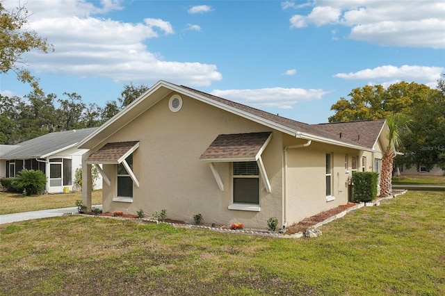 view of home's exterior featuring a sunroom and a yard