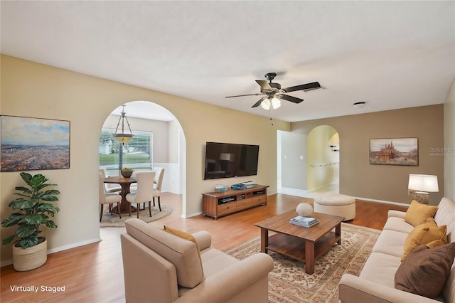 living room with ceiling fan and hardwood / wood-style floors