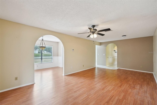 spare room featuring ceiling fan, a textured ceiling, and light wood-type flooring