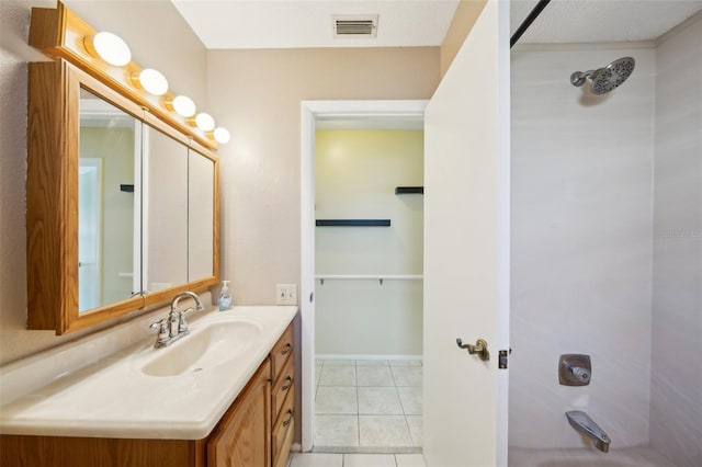 bathroom featuring vanity, tile patterned floors, and shower / bathing tub combination