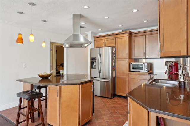 kitchen featuring sink, island range hood, a center island, stainless steel fridge with ice dispenser, and hanging light fixtures