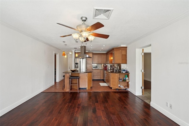 kitchen with island range hood, dark hardwood / wood-style floors, a breakfast bar, and a kitchen island