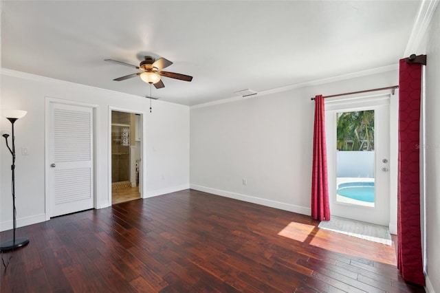 spare room with dark wood-type flooring, ceiling fan, and crown molding