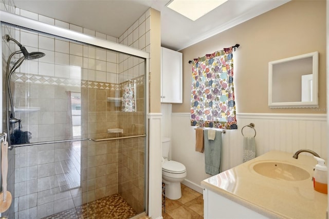 bathroom with walk in shower, vanity, toilet, and tile patterned flooring