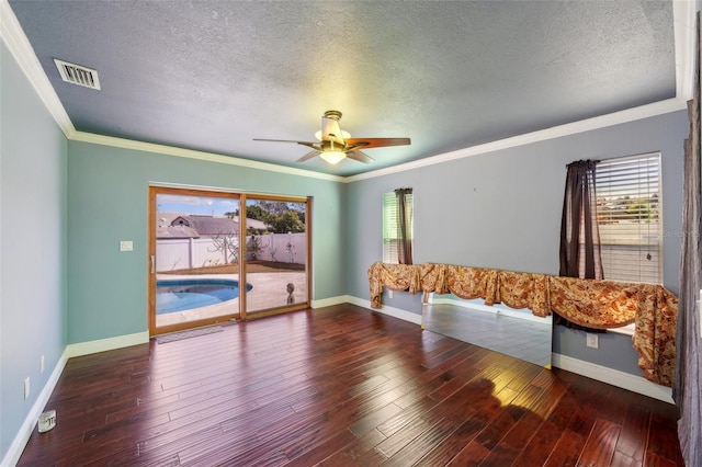 empty room with hardwood / wood-style flooring, ceiling fan, and crown molding