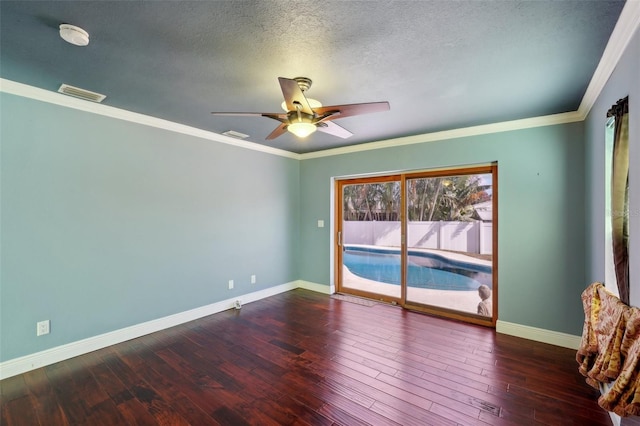 unfurnished room featuring crown molding, ceiling fan, dark wood-type flooring, and a textured ceiling