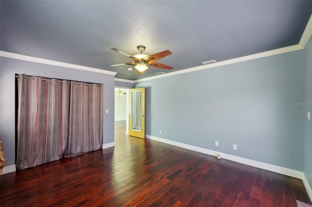 empty room featuring ornamental molding, ceiling fan, and dark hardwood / wood-style flooring