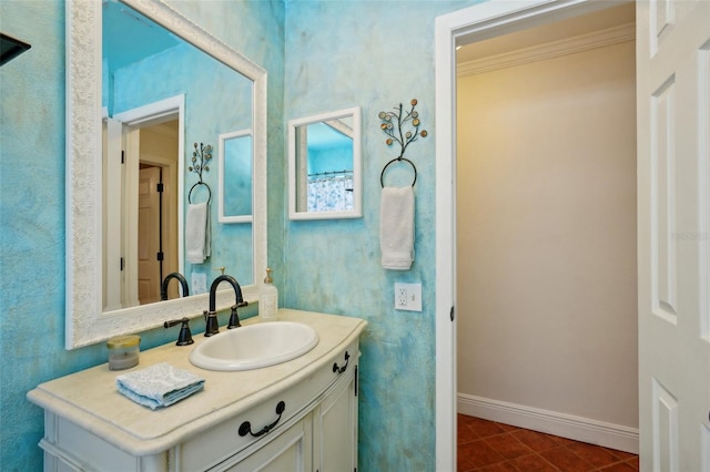 bathroom with ornamental molding, vanity, and tile patterned floors