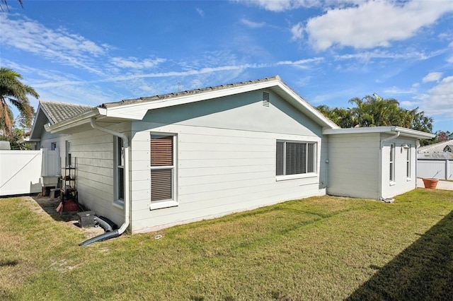 back of property with a lawn