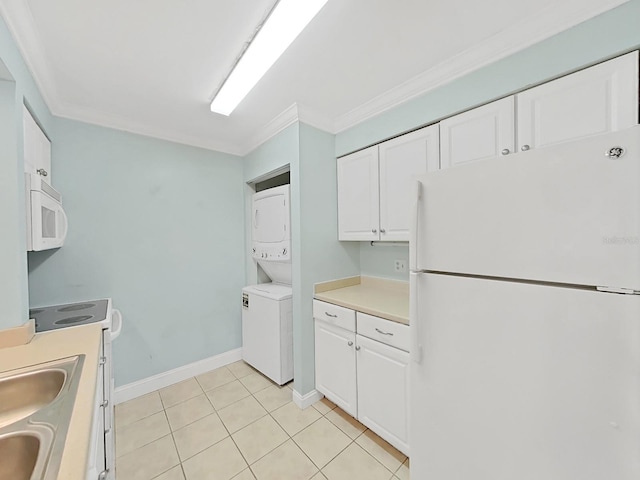 kitchen with white cabinetry, crown molding, light tile patterned floors, white appliances, and stacked washer / dryer