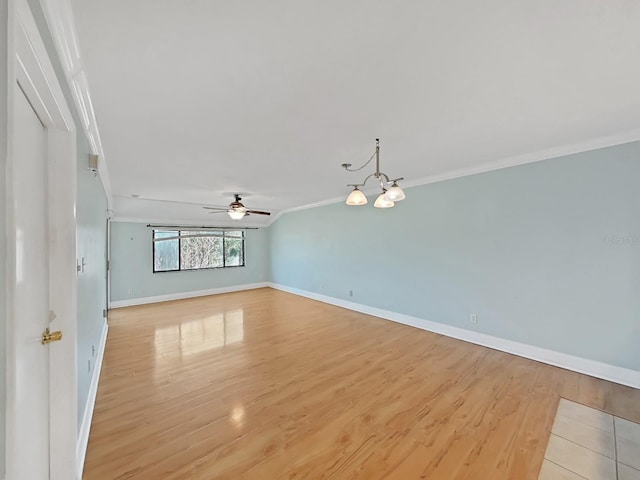 unfurnished room with ornamental molding, ceiling fan with notable chandelier, and light hardwood / wood-style flooring