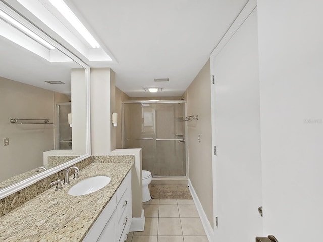 bathroom with vanity, toilet, a shower with shower door, and tile patterned flooring