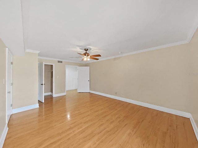 spare room with ornamental molding, ceiling fan, and light wood-type flooring