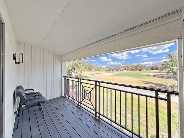 wooden terrace featuring a yard