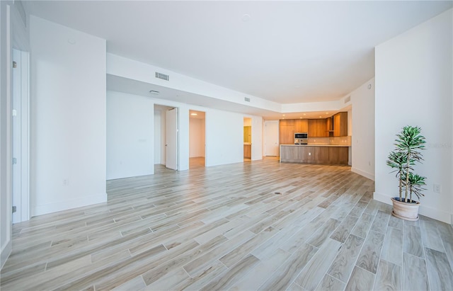 unfurnished living room featuring light wood-type flooring