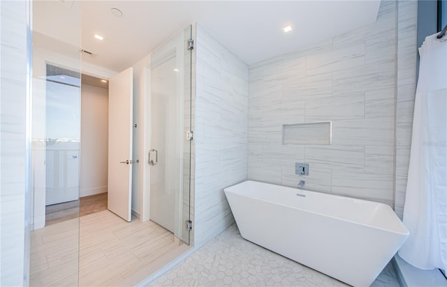 bathroom with plus walk in shower and tile walls