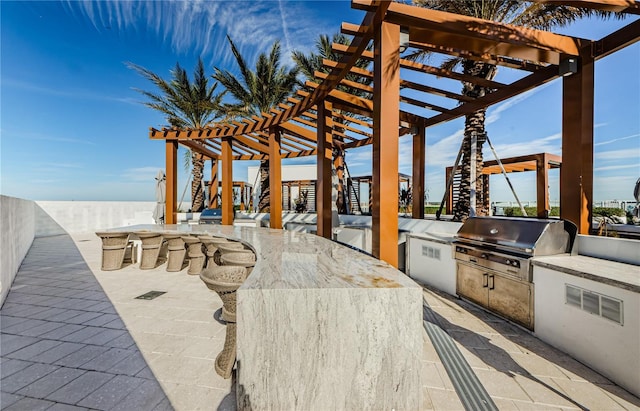 view of patio / terrace with a grill, area for grilling, an outdoor bar, and a pergola