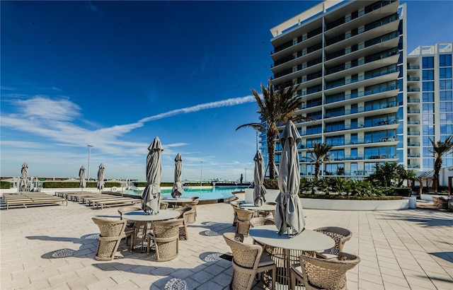 view of patio / terrace with a water view and a community pool