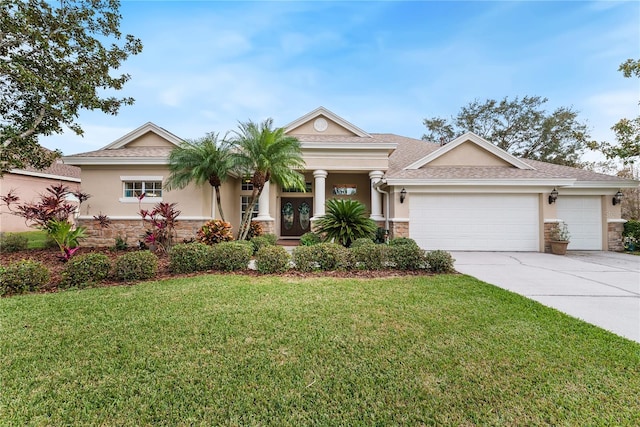 view of front of house featuring a garage and a front lawn