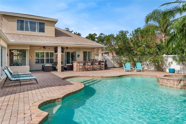 view of swimming pool with outdoor lounge area, a patio, ceiling fan, and an in ground hot tub