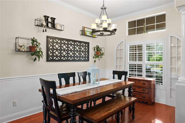 dining room featuring crown molding, an inviting chandelier, and dark wood-type flooring