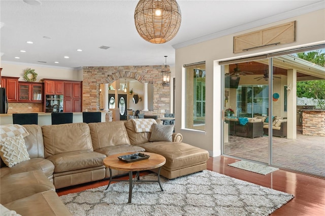 living room featuring crown molding and light hardwood / wood-style floors