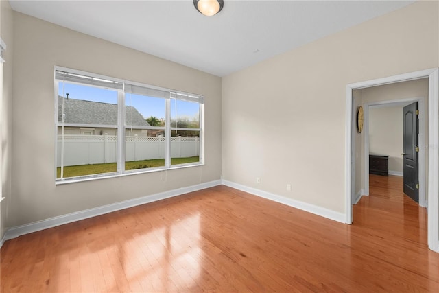 empty room with hardwood / wood-style floors