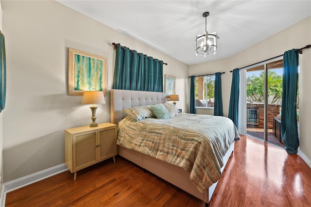 bedroom featuring access to outside, a notable chandelier, and dark hardwood / wood-style flooring