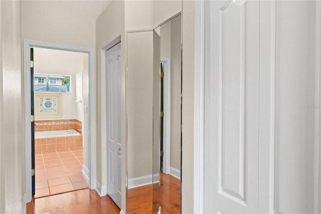 hallway with light hardwood / wood-style flooring