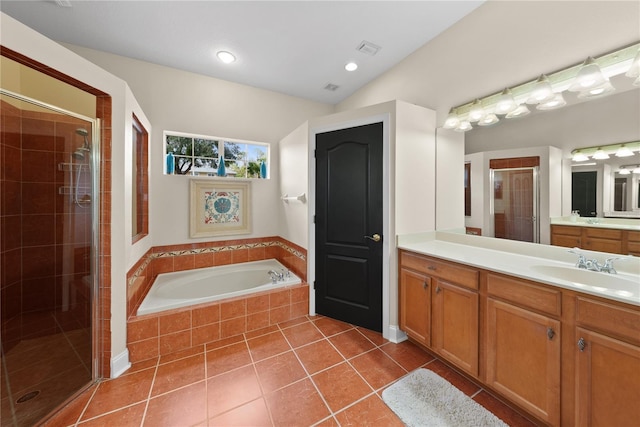 bathroom featuring lofted ceiling, vanity, independent shower and bath, and tile patterned flooring