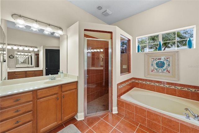 bathroom featuring lofted ceiling, vanity, shower with separate bathtub, and tile patterned flooring