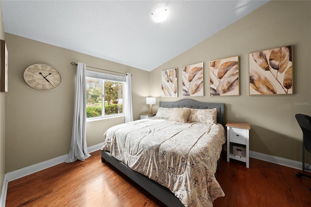 bedroom with hardwood / wood-style flooring and lofted ceiling