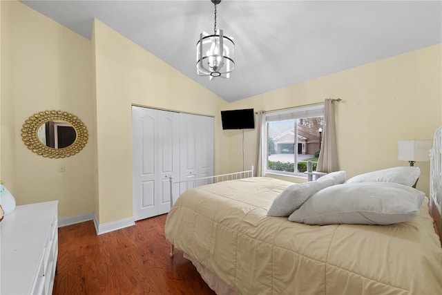 bedroom featuring lofted ceiling, hardwood / wood-style floors, an inviting chandelier, and a closet