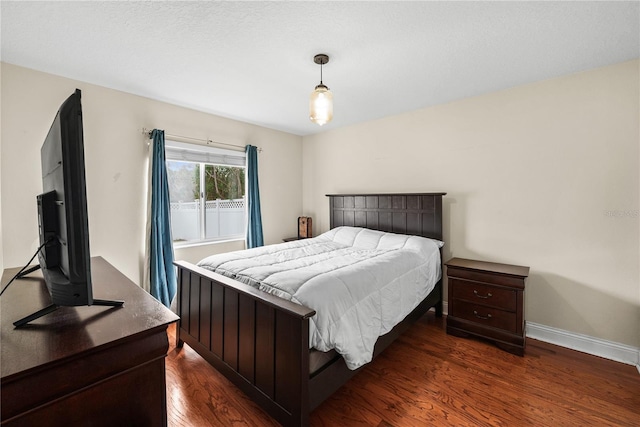 bedroom with dark hardwood / wood-style flooring