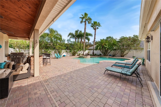 view of swimming pool with grilling area, a patio area, exterior kitchen, and exterior bar