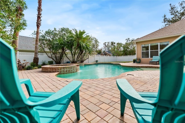 view of swimming pool with an in ground hot tub and a patio area