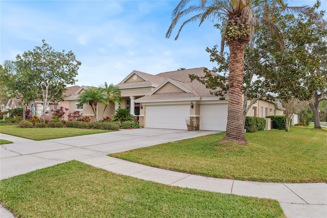 view of front of home with a garage and a front lawn