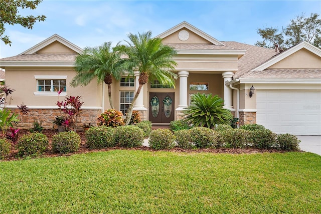 view of front of home with a garage and a front lawn