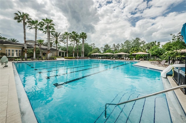 view of pool with a patio area and a water slide