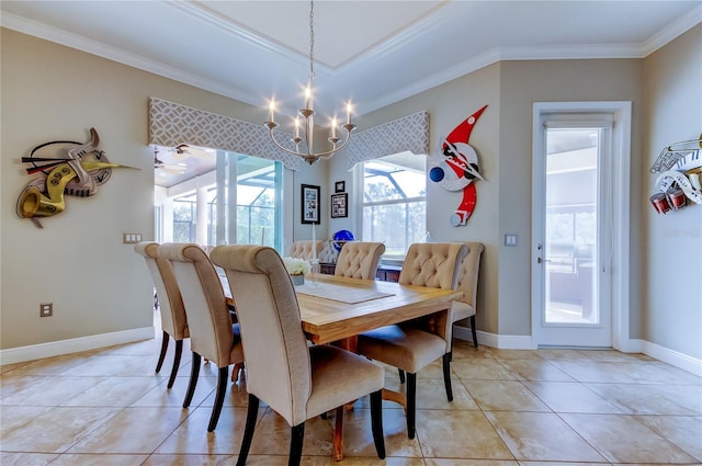 dining space with baseboards, ornamental molding, a notable chandelier, and light tile patterned flooring