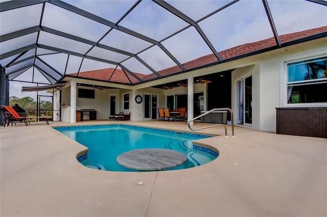 pool featuring a patio, a lanai, and a ceiling fan