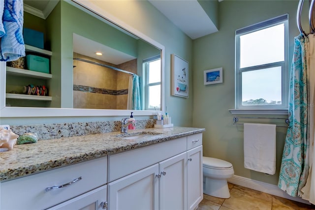 bathroom featuring tile patterned flooring, tiled shower, vanity, and toilet