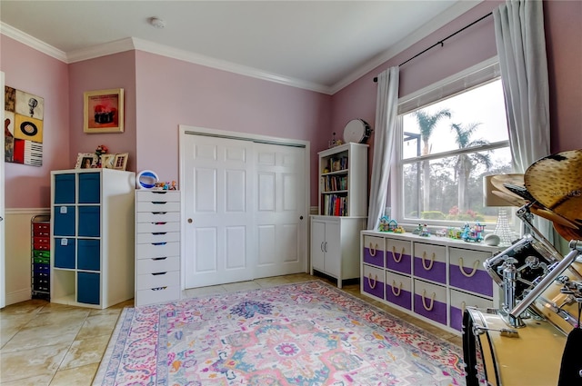 tiled bedroom with ornamental molding and a closet