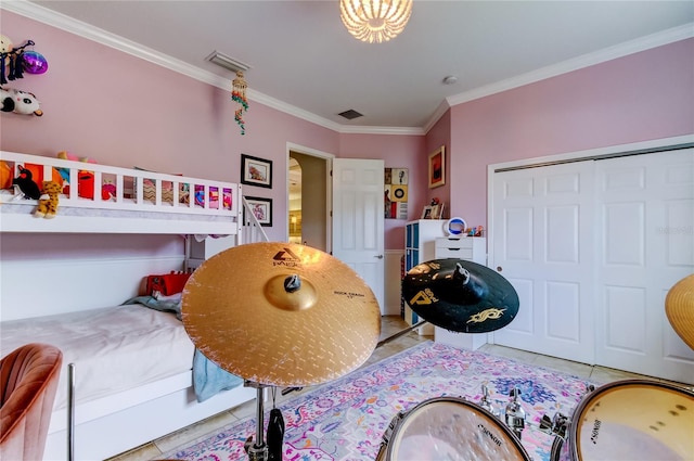 bedroom featuring ornamental molding, tile patterned flooring, a closet, and visible vents