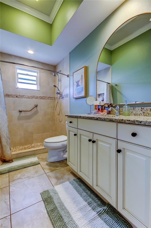 full bath featuring toilet, ornamental molding, tile patterned floors, a tile shower, and vanity