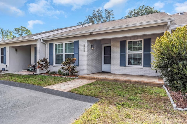 ranch-style home with a porch and a front yard