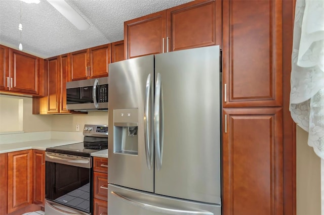 kitchen featuring stainless steel appliances and a textured ceiling