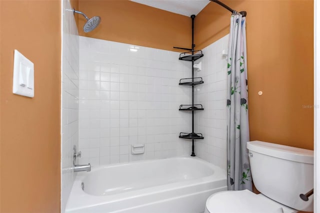 bathroom featuring shower / tub combo and toilet