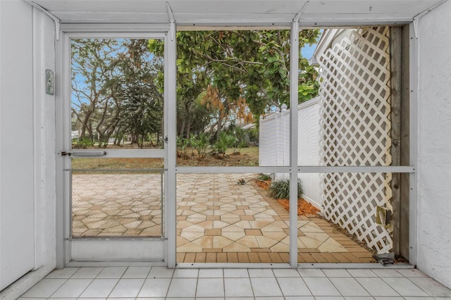 doorway to outside featuring light tile patterned flooring