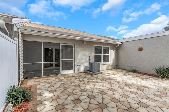 view of patio / terrace featuring a sunroom and central air condition unit